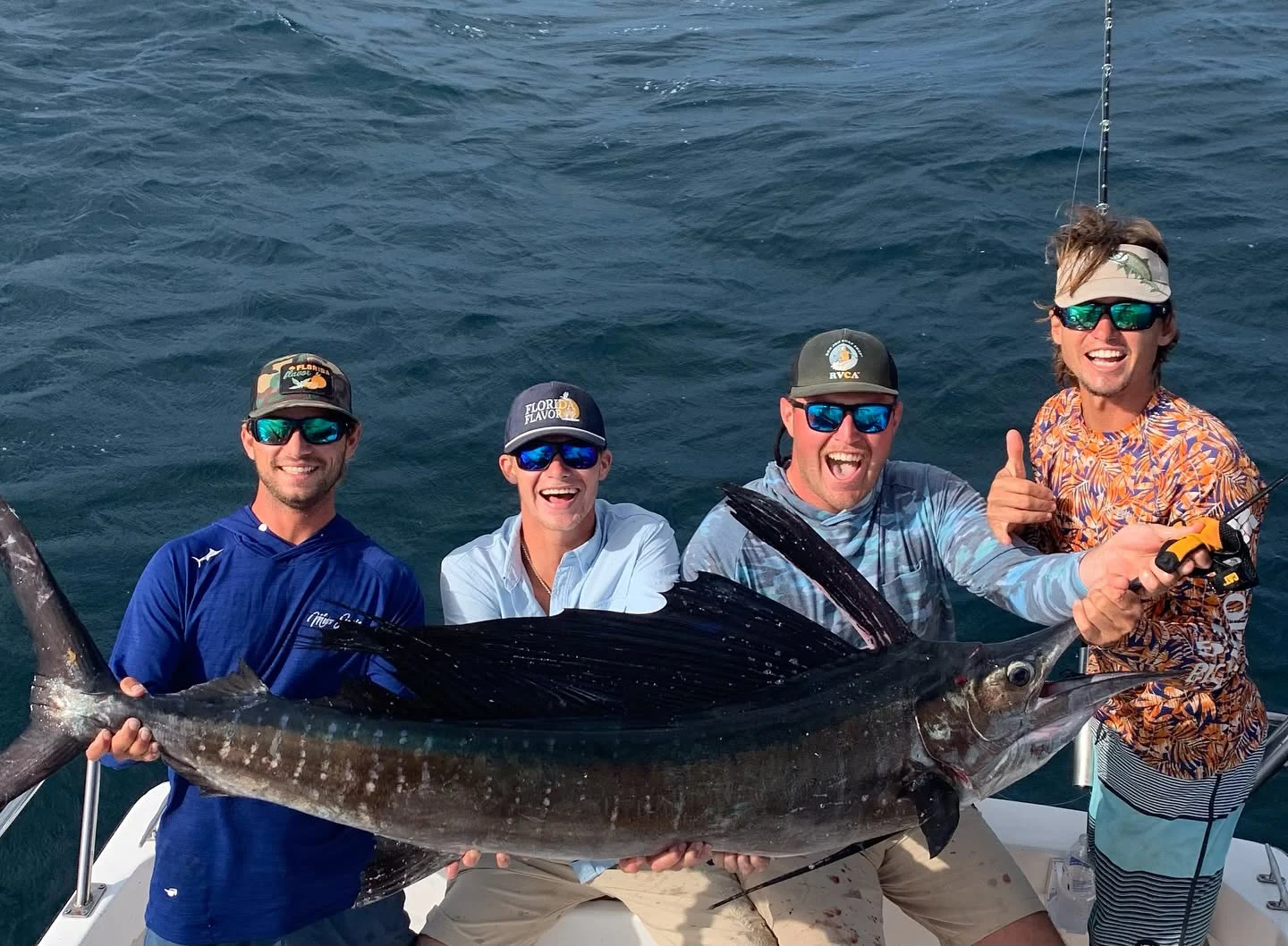 Group of anglers with a trophy sailfish during a Sarasota custom fishing charter.
