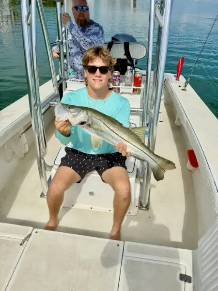 Angler holding a snook caught during a Sarasota fishing trip on September 14, 2026.